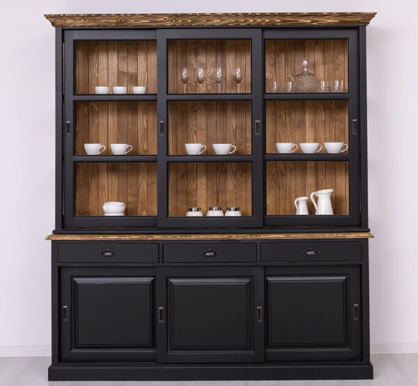 Landelijke buffetkast met zes schuifdeuren en drie lades. De onderkant van de kast zie je 3 schuifdeuren met daarboven 3 lades. De bovenkant van de kast heeft drie lange schuifdeuren met glas. Gemaakt van massief eiken hout in de kleur zwart met wax finish bruin. De buffetkast kan op verschillende manieren geverfd worden in verschillende kleuren en kan op maat gemaakt worden. Villa Laura